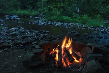 Campfire beside a brook