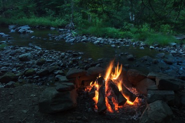 Campfire beside a brook Campfire beside a brook